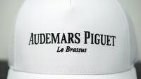 Close-up view of Audemars Piguet logo on white cotton hat