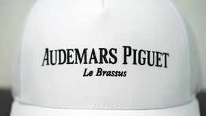 Close-up view of Audemars Piguet logo on white cotton hat