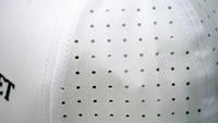 Close-up view of Audemars Piguet white cotton perforated material