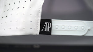 Close-up view of AP label on white cotton Audemars Piguet sports hat