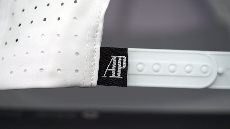 Close-up view of AP label on white cotton Audemars Piguet sports hat