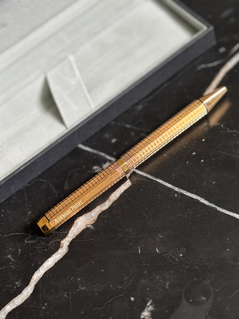 Side profile of Audemars Piguet Royal Oak yellow gold finish ballpoint pen showing brushed and polished surfaces