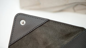 Close-up of Audemars Piguet leather pouch with embossed logo and premium stitching