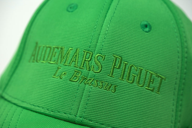 Close-up of embroidered Audemars Piguet logo and “Le Brassus” text on the lime green hat