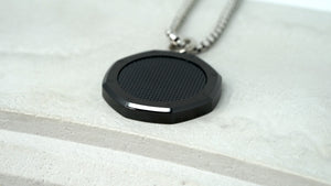 Side profile of slim, black carbon Royal Oak medallion pendant for chain