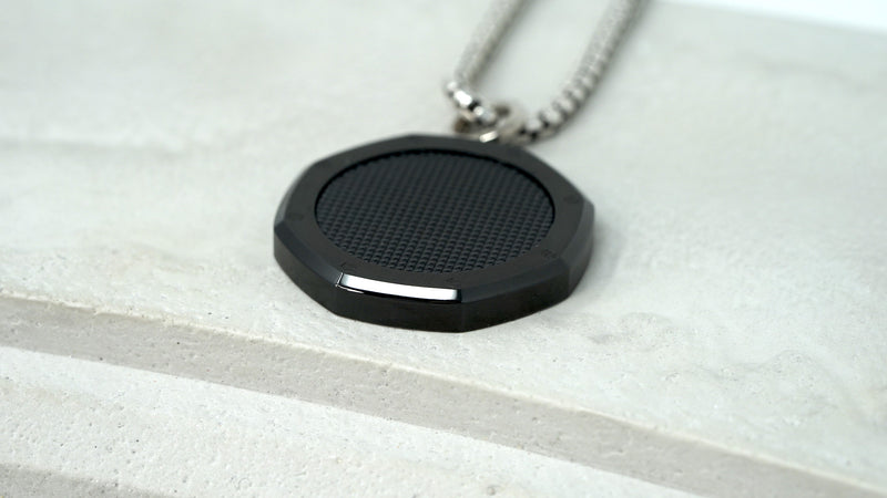 Side profile of slim, black carbon Royal Oak medallion pendant for chain